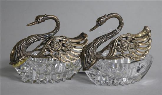 A pair of 1980s repousse silver mounted cut glass sweetmeat dishes modelled as swans, height 4in.